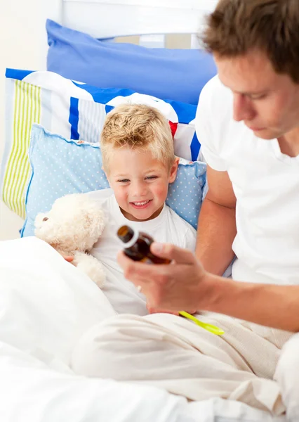 Caring man looking after his sick son — Stock Photo, Image
