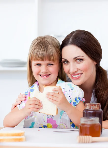 Charming mother and her daughter having breakfast — Stock Photo, Image