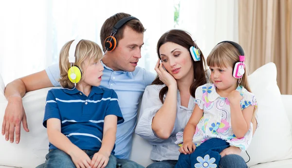Familie luisteren muziek met koptelefoon — Stockfoto