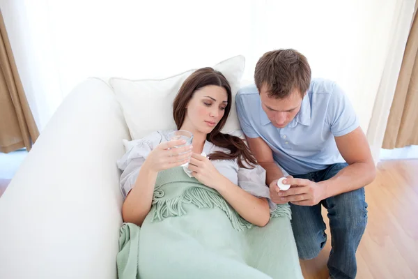 Man giving pills to his sick wife — Stock Photo, Image