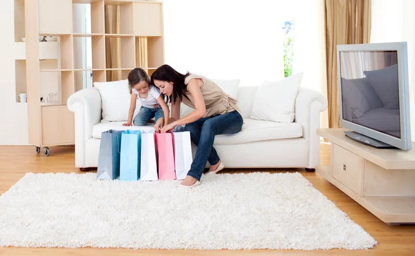 Jolly mother and her daughter at home after shopping — Stock Photo, Image