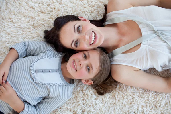 Счастливая мать и ее девочка лежат на полу — стоковое фото