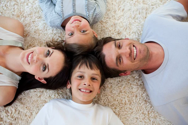 Op de vloer liggen en gelukkige familie — Stockfoto