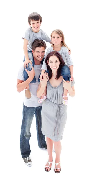 Smiling parents giving their children piggyback ride — Stock Photo, Image