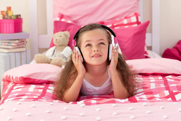 Linda chica escuchando música en el dormitorio —  Fotos de Stock