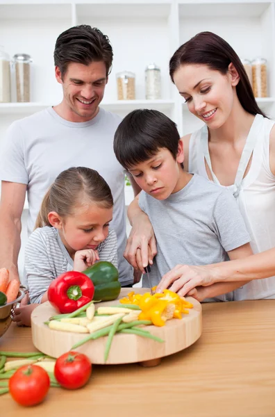 Happy parents and children cooking — Stock Photo, Image