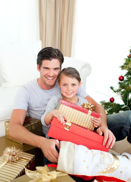 Menina feliz com seu pai segurando um presente de Natal — Fotografia de Stock
