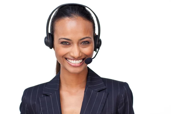 Beautiful ethnic businesswoman with a headset on smiling at the — Stock Photo, Image