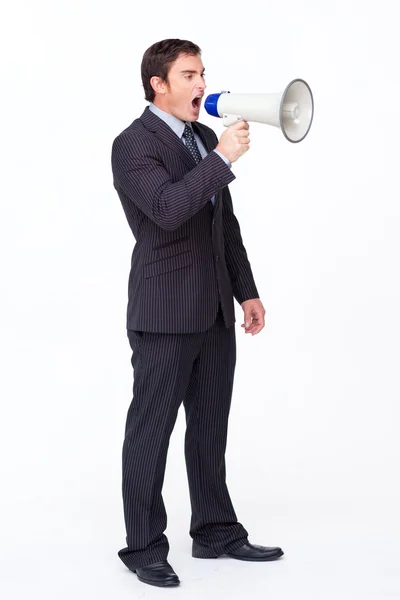 Standing businessman shouting through a megaphone — Stock Photo, Image