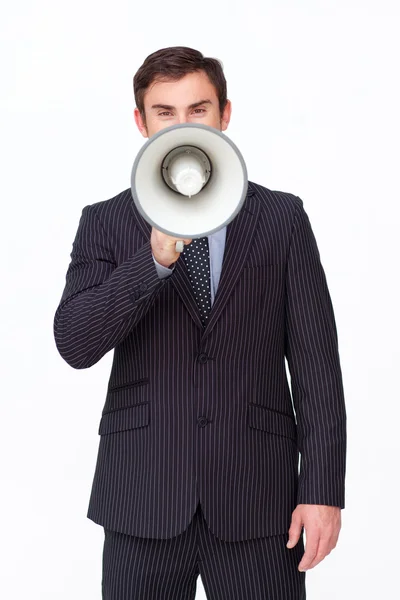 Young businessman shouting through a megaphone — Stock Photo, Image