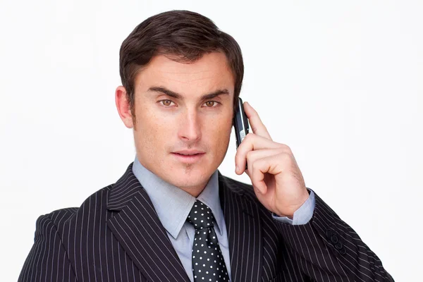 Portrait of a serious businessman on phone against white — Stock Photo, Image