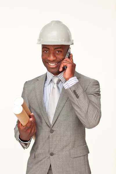 Attractive ethnic architect on phone holding plans — Stock Photo, Image