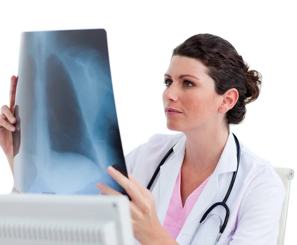 Pensive female doctor looking at X-ray in his office — Stock Photo, Image