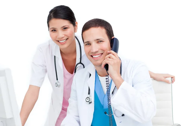 Charming doctor and his colleague on phone — Stock Photo, Image