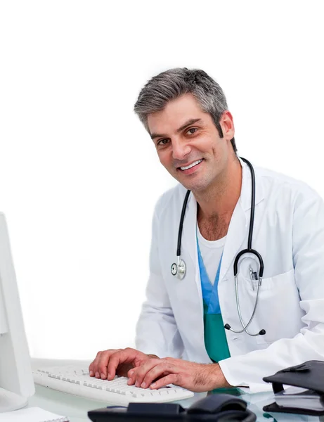 Mature male doctor working at a computer — Stock Photo, Image