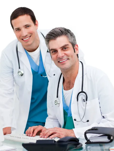 Two handsome male doctors working at a computer — Stock Photo, Image