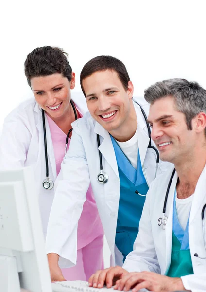 Χαμογελώντας ομάδα ιατρών που εργάζονται σε έναν υπολογιστή — Φωτογραφία Αρχείου