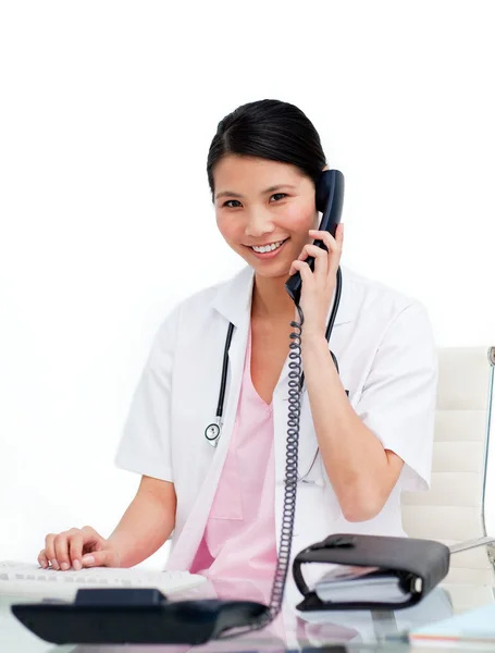 Asian doctor talking on phone — Stock Photo, Image