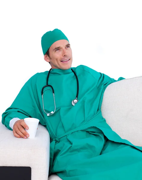 Relaxed surgeon drinking coffee in the staff room — Stock Photo, Image