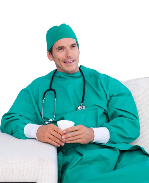 Handsome surgeon drinking coffee in the staff room — Stock Photo, Image