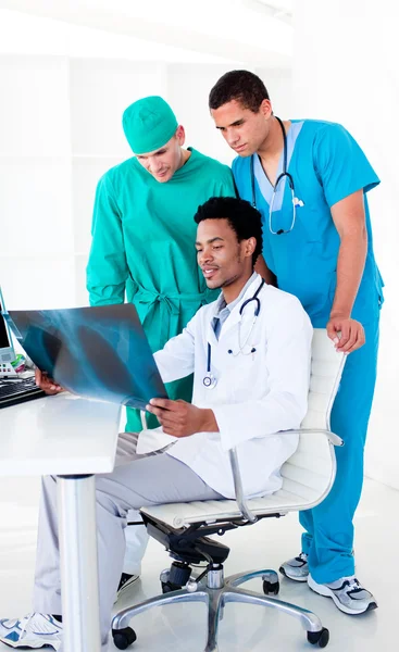 Serious male doctors looking at X-Ray — Stock Photo, Image