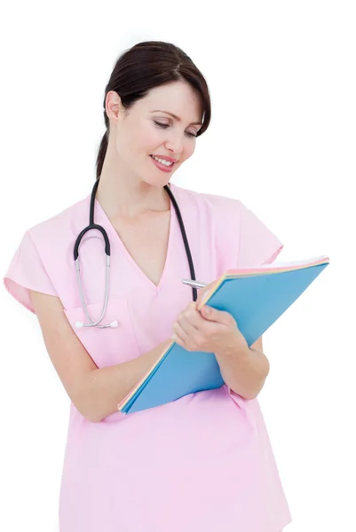 Serious young nurse taking notes — Stock Photo, Image