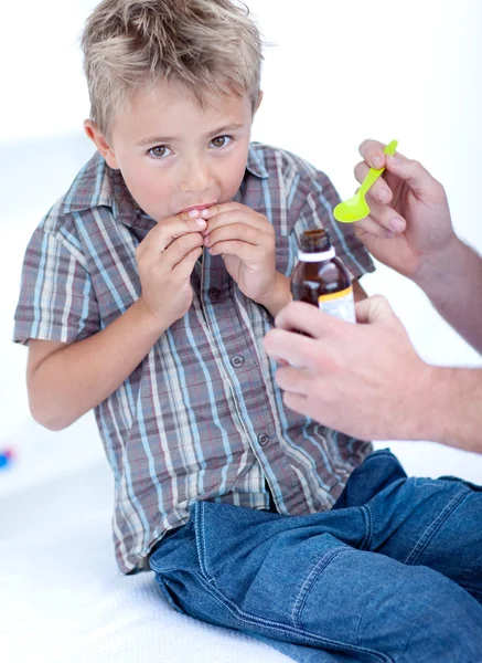 Cold child taking syrup — Stock Photo, Image