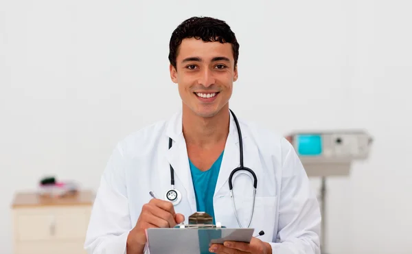 Young male Doctor holding a clip board — Stock Photo, Image