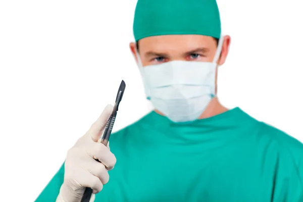 Concentrated surgeon holding a scalpel — Stock Photo, Image