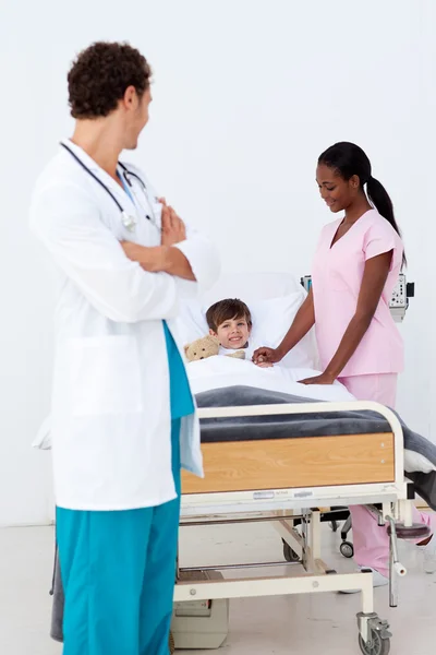 Pediatra i pielęgniarka uczestniczy dziecko w szpitalu — Zdjęcie stockowe