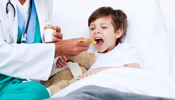 Little boy taking cough medicine — Stock Photo, Image
