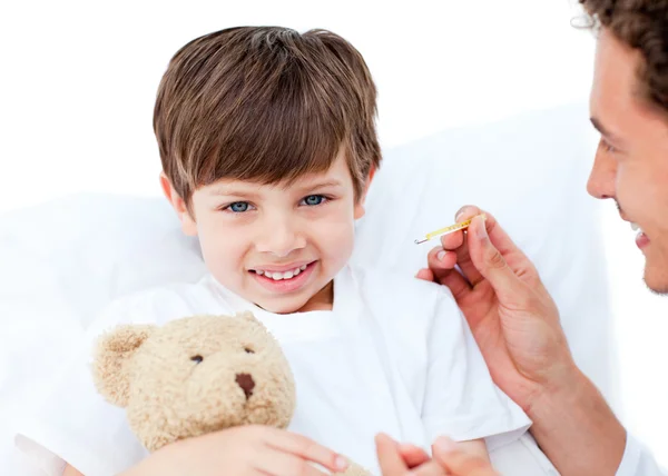Joyful doctor taking little boy's temperature — Stock Photo, Image