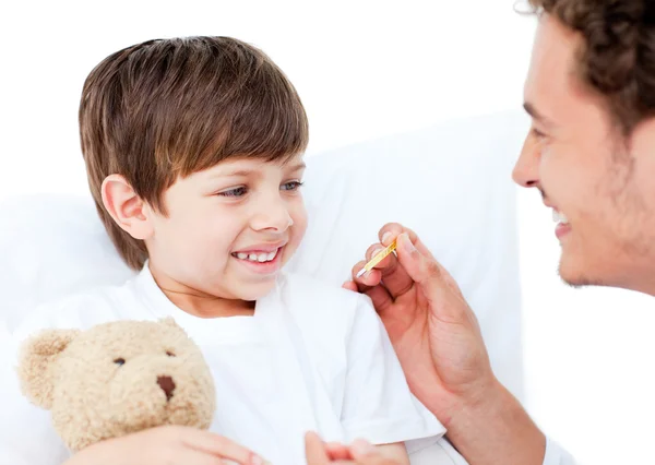 Enthusiastic doctor taking little boy's temperature — Stock Photo, Image