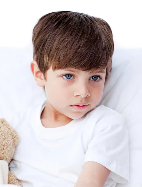 Sick little boy lying in a hospital bed — Stock Photo, Image