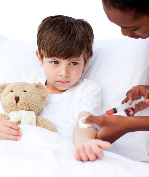 Sick little boy receiving an injection — Stock Photo, Image