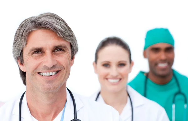 Focus on a mature doctor in front of his team — Stock Photo, Image