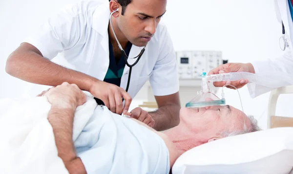 Serious doctor resuscitating a patient — Stock Photo, Image