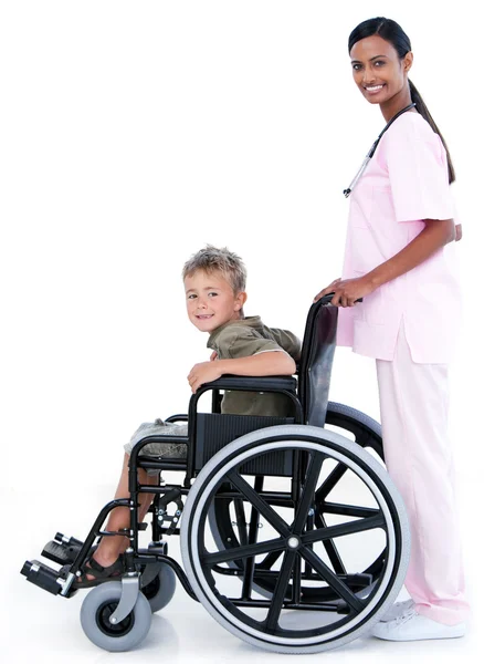 Przebojowa kobieta lekarz prowadzenie pacjenta na wózku inwalidzkim — Zdjęcie stockowe
