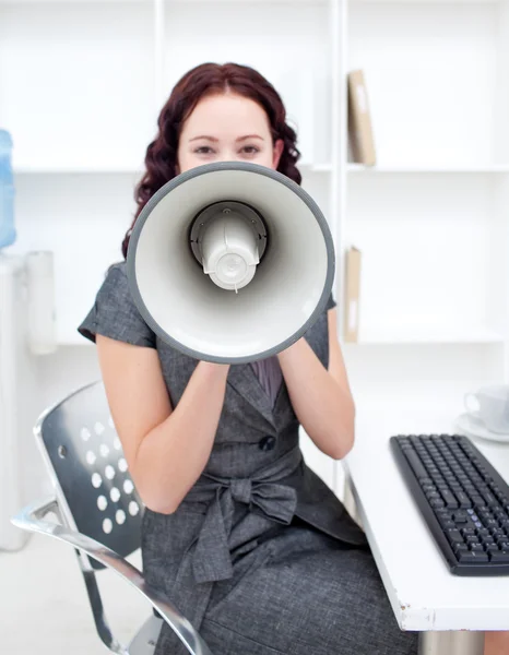 Businesswoman shouting through a megaphone — Stock Photo, Image