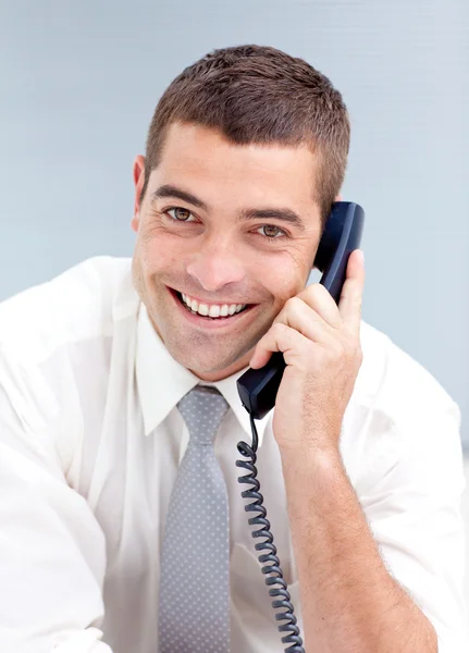 Attractive businessman on phone in office — Stock Photo, Image