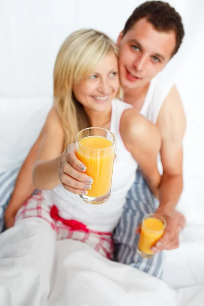 Woman holding a glass of orange juice — Stock Photo, Image