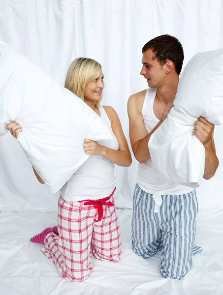 Young couple having a pillow fight — Stock Photo, Image