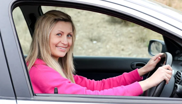 Улыбающаяся женщина-водитель за рулем — стоковое фото