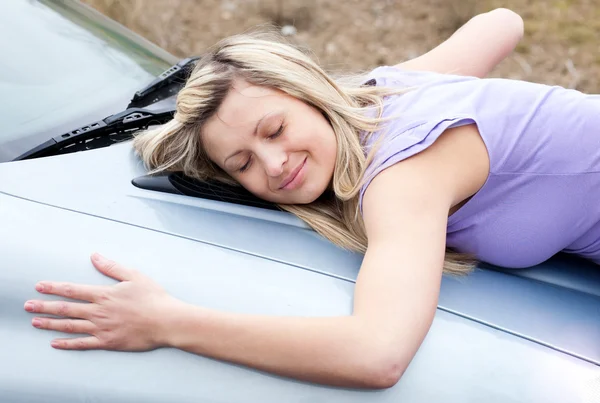 Cheerful female driver huging her new car — Stock Photo, Image