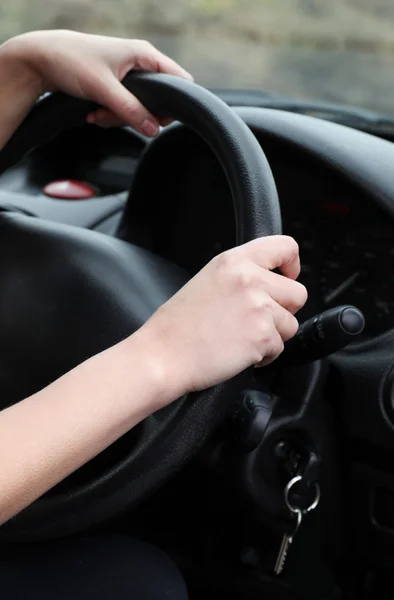Close-up of a young female driver at the wheel — Stock Photo, Image