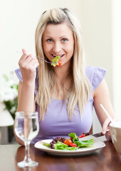 Retrato de uma mulher encantadora comendo uma salada — Fotografia de Stock