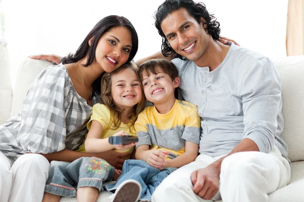 Famille joyeuse regarder la télévision ensemble — Photo