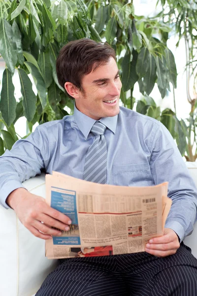 stock image Relaxed businessman reading a newspaper