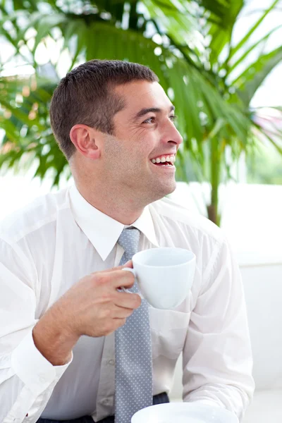 Happy businessman relaxing with a cup of coffee — Stock Photo, Image