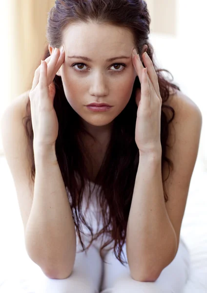 Brunette woman having a headache in bed — Stock Photo, Image